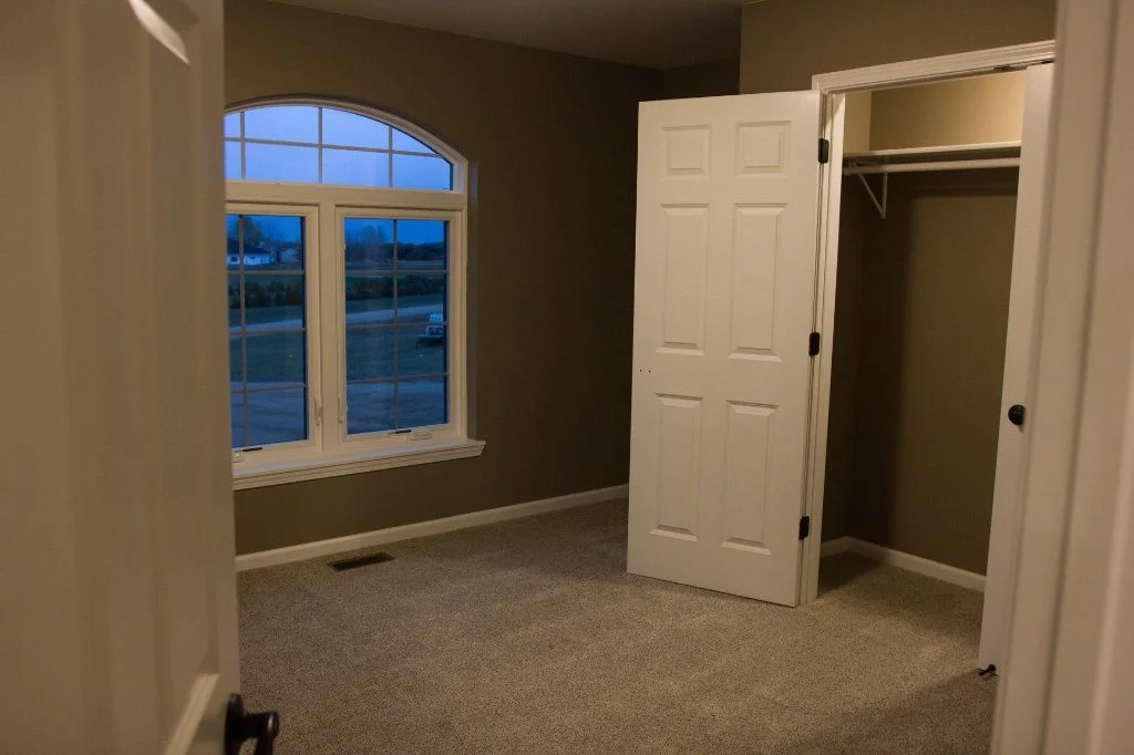 Anasazi Builders Custom Bedroom with Arched Window and Closet.