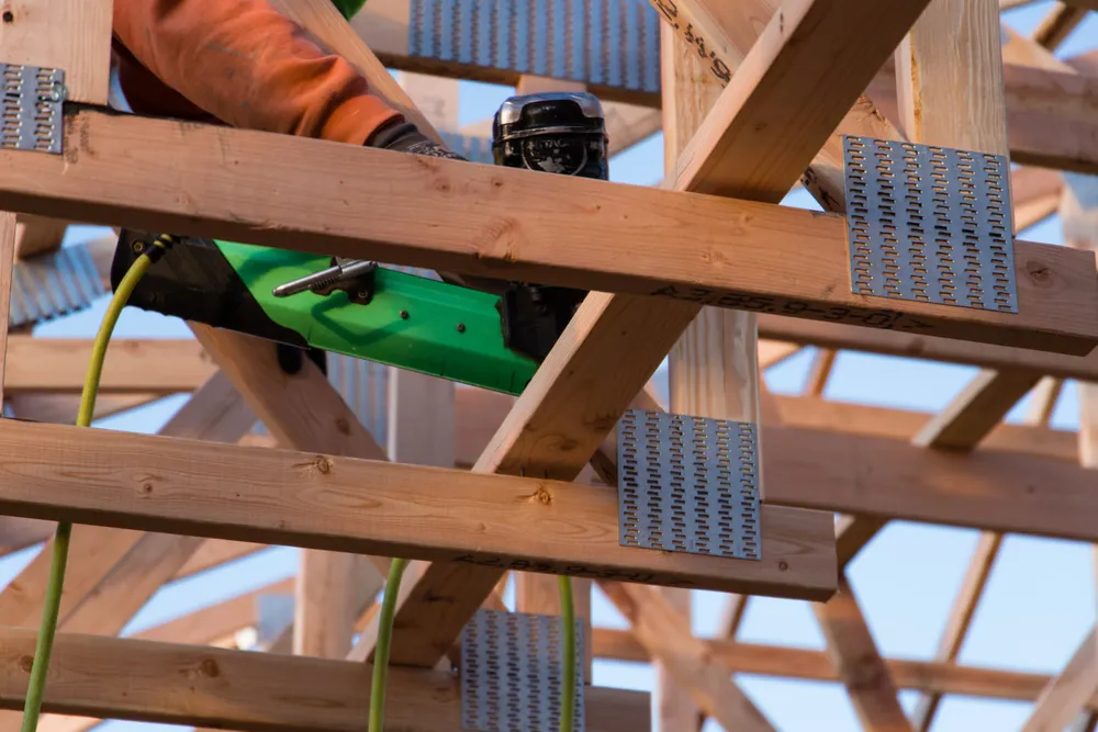 Floor joists anchored to a permitted custom-home foundation at an Anasazi Builders Tri-Cities jobsite