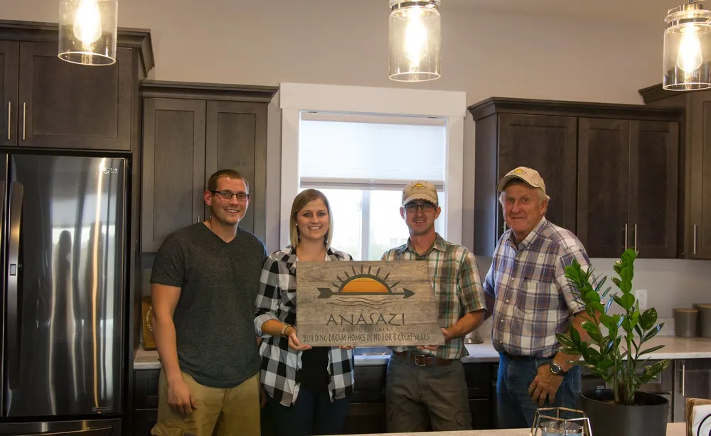 Anasazi Builders founders John and Stephen with homeowners in a finished Benton County kitchen