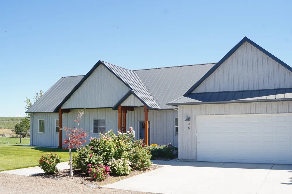 Completed modern grey custom home by Anasazi Builders ready for exterior walkthrough and handover